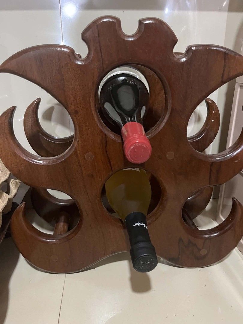 Wooden Wine Rack And Serving Trays Bundle Take All (Category: Shelves, Cabinets & Racks) located in Cagayan de Oro. Submitted by che21822 (Listing ID 1470781314, Image 1). Description: - Solid dark wood wine rack with a deep rich grain finish - Securely holds multiple wine bottles - Includes a unique two-tiered floral-shaped stand - Comes with two rectangular serving trays featuring recessed centers - Magkuno Wood - Perfect setup for home dining,