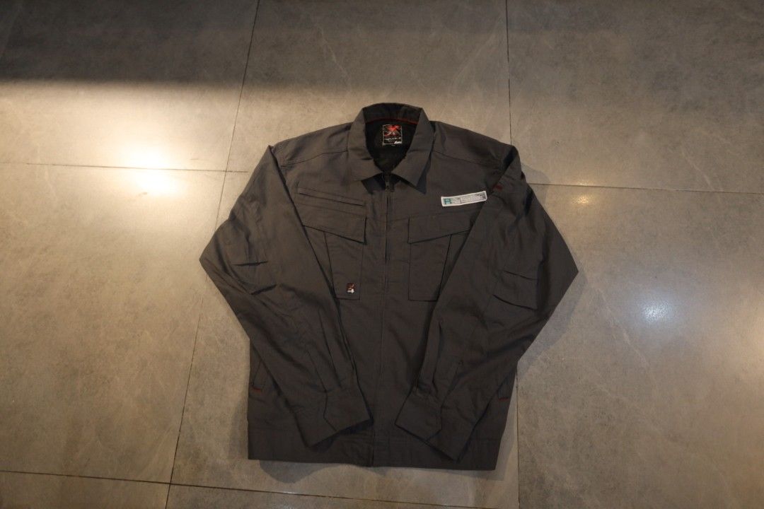 XEBEC Gray Work Jacket Utility Pocket Long Sleeve (Category: Coats, Jackets and Outerwear) located in Manila. Submitted by krzxyprk (Listing ID 1470771576, Image 1). Description: - Color: Gray - Style: Long sleeve work jacket with zip-up front - Pockets: Multiple chest pockets and utility details on sleeves - Design: Structured collar and clean interior lining with red accent piping - Material: Durable, high-quality fabric.