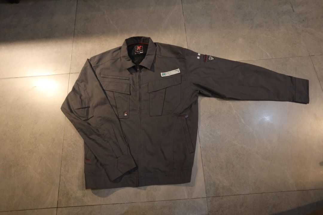 XEBEC Gray Work Jacket Utility Pocket Long Sleeve (Category: Coats, Jackets and Outerwear) located in Manila. Submitted by krzxyprk (Listing ID 1470771576, Image 2). Description: - Color: Gray - Style: Long sleeve work jacket with zip-up front - Pockets: Multiple chest pockets and utility details on sleeves - Design: Structured collar and clean interior lining with red accent piping - Material: Durable, high-quality fabric.