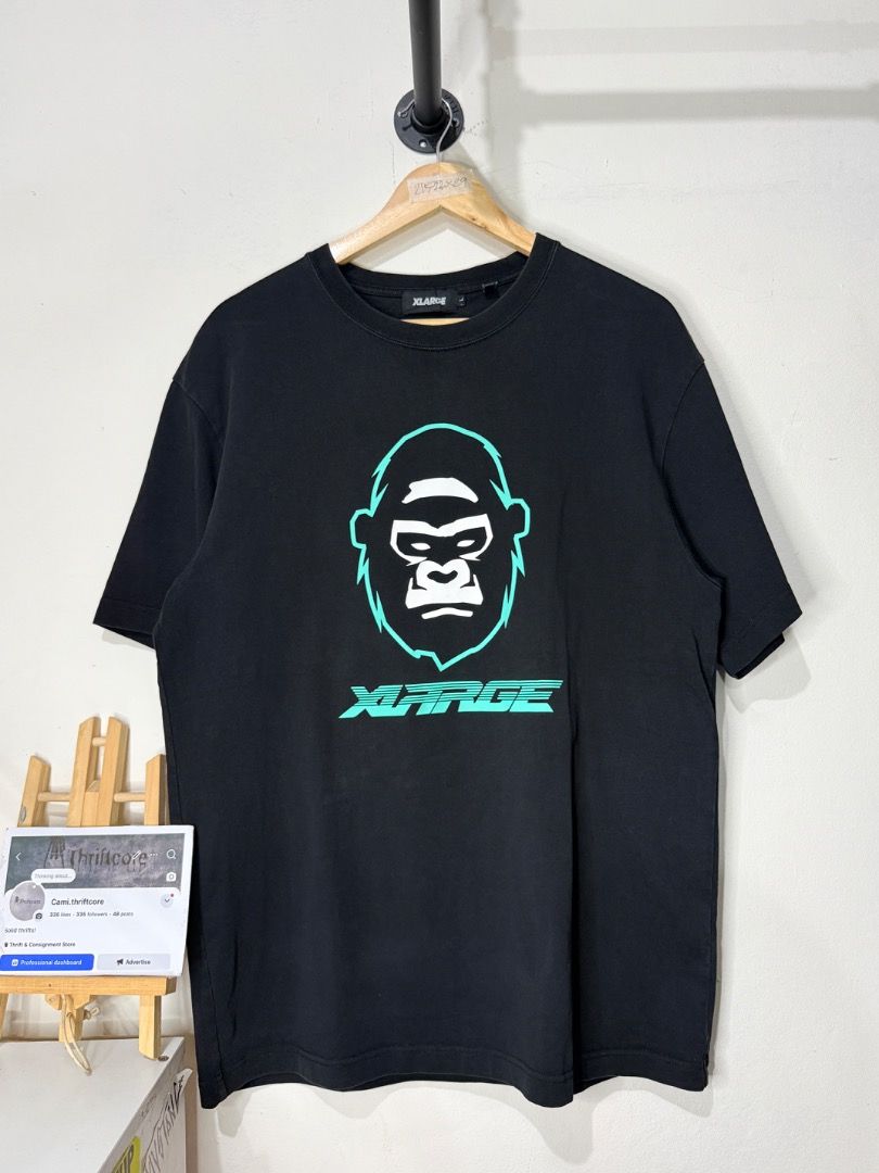 Xlarge Gorilla Graphic Black T-Shirt (Category: Tshirts & Polo Shirts ) located in Caloocan City. Submitted by choidelfin.420 (Listing ID 1470824708, Image 1). Description: - Brand: Xlarge - Color: Black - Size: L - Material: Cotton with comfortable stretch - Design: Bold white & teal gorilla graphic on chest, logo text on back collar - Pit to Pit: 21.5 inches - Shoulder to Hem: 23 inches - Length: 29 inches.