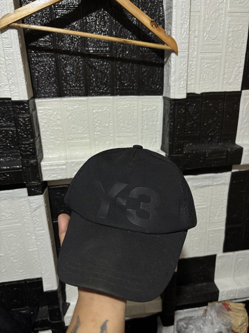 Y-3 Black Snapback Cap with Debossed Logo (Category: Caps & Hats) located in Lopez. Submitted by thrift.ni.roms22 (Listing ID 1470760168, Image 1). Description: Black Y-3 cap with a tonal debossed logo front panel. Breathable mesh side and back panels with ventilation eyelets on top. Adjustable plastic snapback closure in the back. Minimalist streetwear piece, goes with everything..