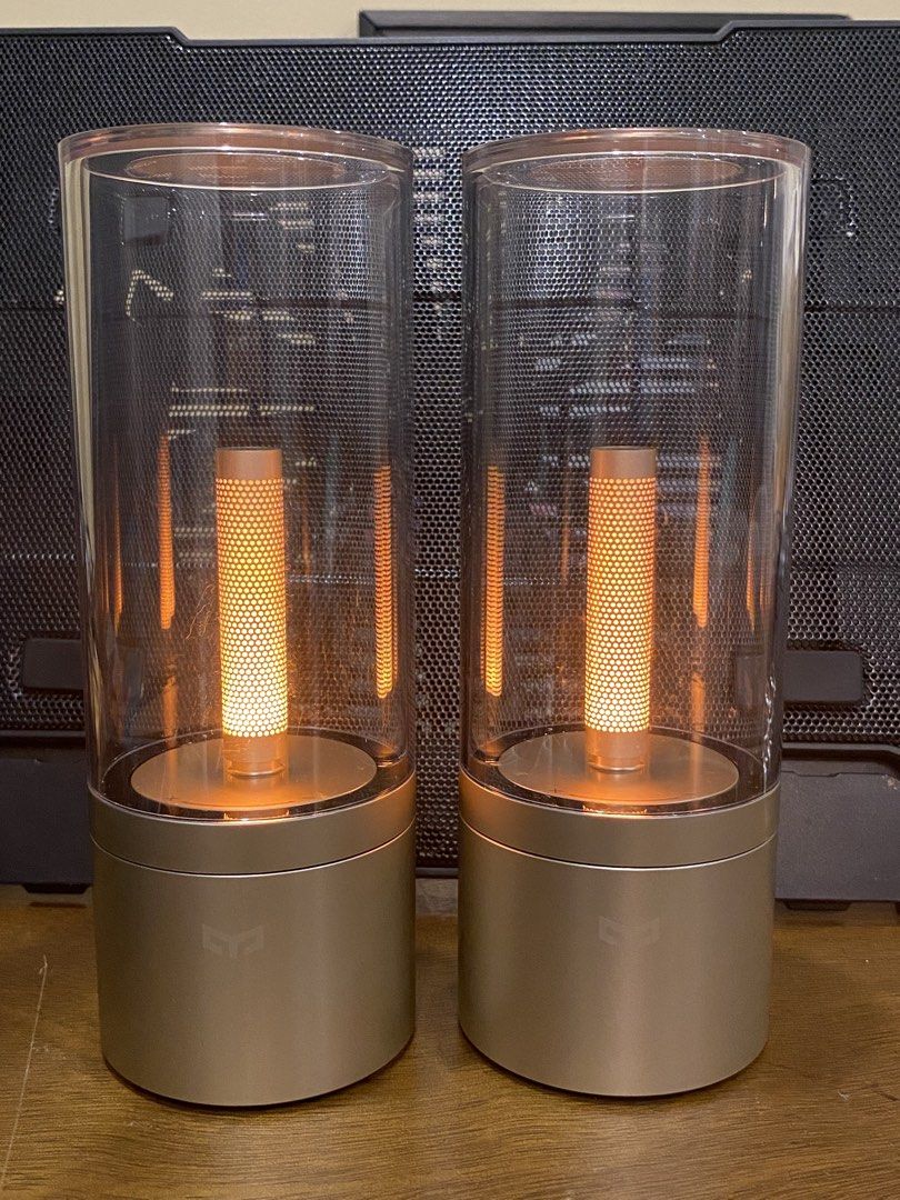 Yeelight Candela Ambiance Lamp Bluetooth Smart Pair (Category: Lighting) located in Santa Rosa. Submitted by hoardqueensdeclutter (Listing ID 1470869016, Image 3). Description: - Model: Yeelight Candela Ambiance Lamp (YL060) - Quantity: Pair (selling both together) - Design: Gold base with clear glass cylinder - Features: Bluetooth smart connectivity, warm glow candle effect, bottom power switch, reset button, and charging port - Mfg Date: 05/201