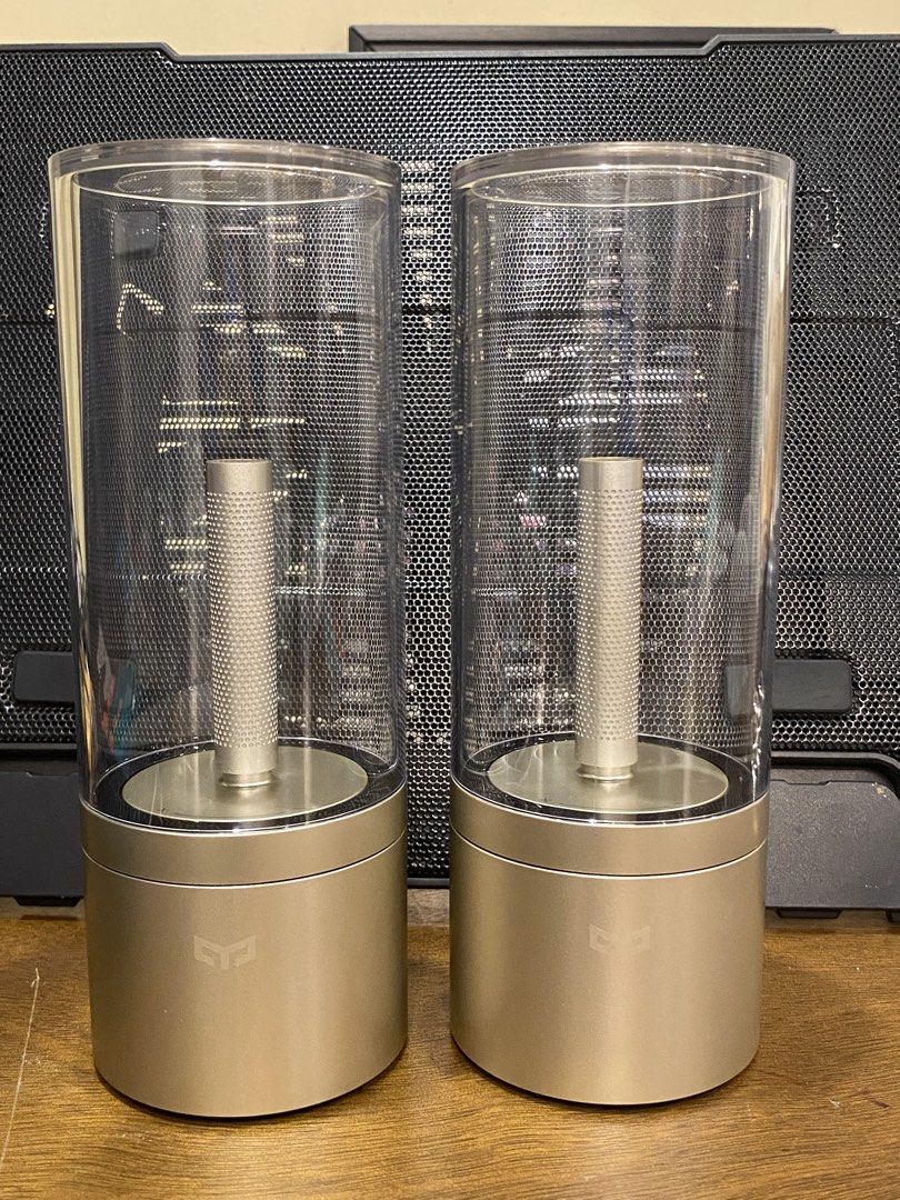 Yeelight Candela Ambiance Lamp Bluetooth Smart Pair (Category: Lighting) located in Santa Rosa. Submitted by hoardqueensdeclutter (Listing ID 1470869016, Image 1). Description: - Model: Yeelight Candela Ambiance Lamp (YL060) - Quantity: Pair (selling both together) - Design: Gold base with clear glass cylinder - Features: Bluetooth smart connectivity, warm glow candle effect, bottom power switch, reset button, and charging port - Mfg Date: 05/201