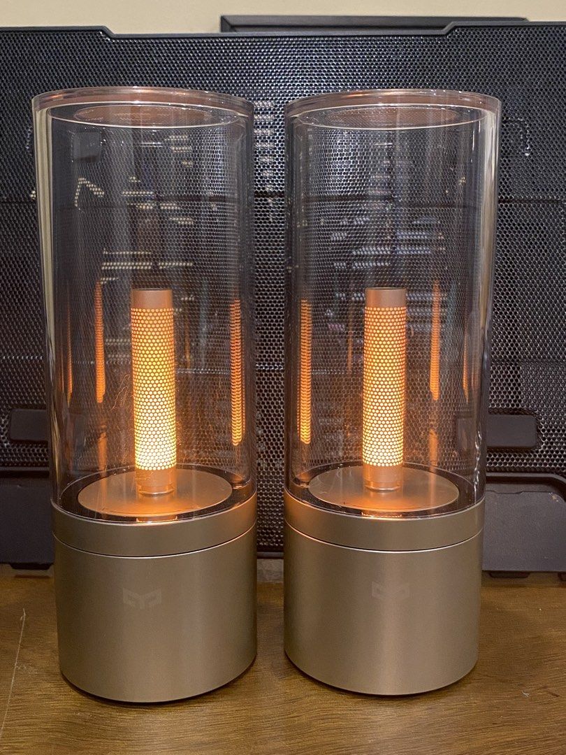 Yeelight Candela Ambiance Lamp Bluetooth Smart Pair (Category: Lighting) located in Santa Rosa. Submitted by hoardqueensdeclutter (Listing ID 1470869016, Image 2). Description: - Model: Yeelight Candela Ambiance Lamp (YL060) - Quantity: Pair (selling both together) - Design: Gold base with clear glass cylinder - Features: Bluetooth smart connectivity, warm glow candle effect, bottom power switch, reset button, and charging port - Mfg Date: 05/201