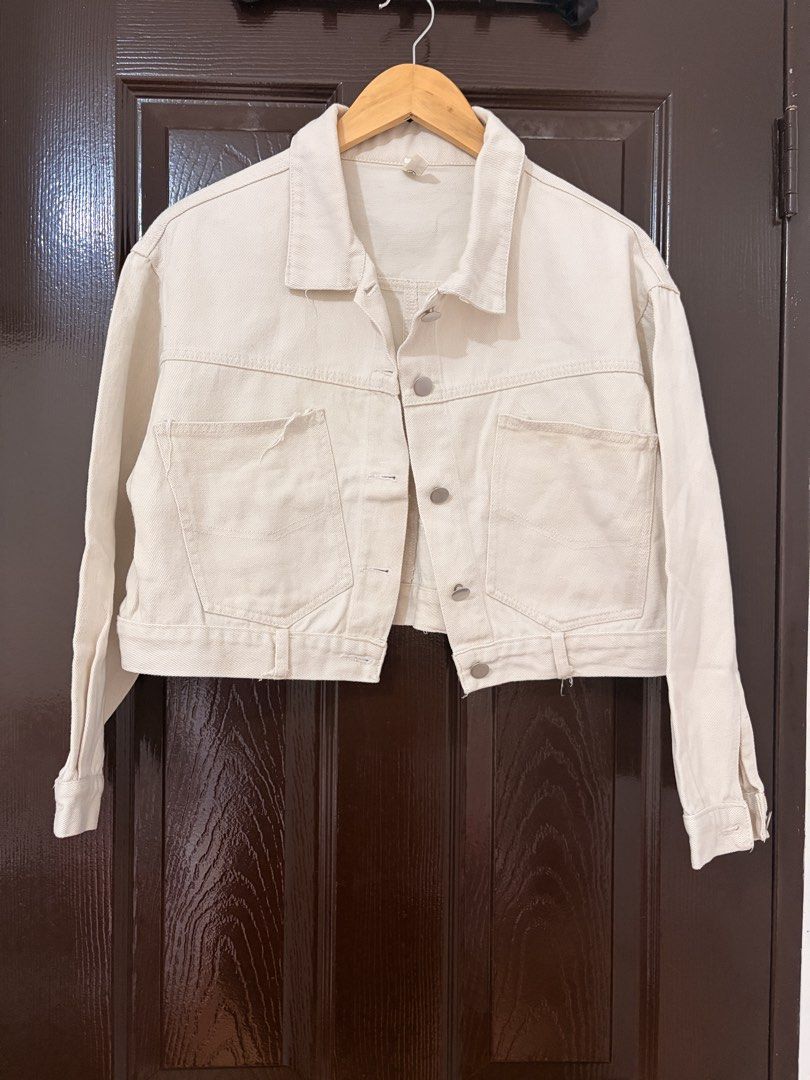 Yidola Cream Cropped Denim Jacket (Category: Coats, Jackets and Outerwear) located in Marikina City. Submitted by _bananahanaa (Listing ID 1470796912, Image 1). Description: - Brand: Yidola - Color: Cream - Style: Cropped denim jacket with button-up front and collar - Pockets: Large utility pockets on chest and matching pockets on back hem - Hardware: Silver-tone metal buttons and hardware - Material: 100% unlined cotton, perfect for layering, de