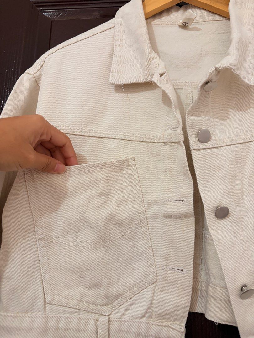 Yidola Cream Cropped Denim Jacket (Category: Coats, Jackets and Outerwear) located in Marikina City. Submitted by _bananahanaa (Listing ID 1470796912, Image 3). Description: - Brand: Yidola - Color: Cream - Style: Cropped denim jacket with button-up front and collar - Pockets: Large utility pockets on chest and matching pockets on back hem - Hardware: Silver-tone metal buttons and hardware - Material: 100% unlined cotton, perfect for layering, de