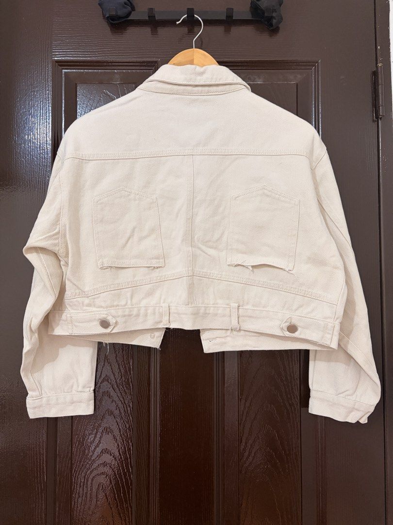 Yidola Cream Cropped Denim Jacket (Category: Coats, Jackets and Outerwear) located in Marikina City. Submitted by _bananahanaa (Listing ID 1470796912, Image 2). Description: - Brand: Yidola - Color: Cream - Style: Cropped denim jacket with button-up front and collar - Pockets: Large utility pockets on chest and matching pockets on back hem - Hardware: Silver-tone metal buttons and hardware - Material: 100% unlined cotton, perfect for layering, de