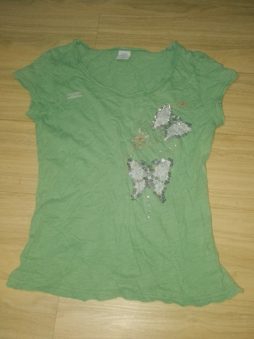 Green Butterfly Sequins T-shirt Size S (Category: Shirts) located in Naga. Submitted by francethriftee3 (Listing ID 1470803931, Image 1). Description: Location: Camarines Sur, Bicol - Brand: Yizhichun - Size: Small (155/80A) - Color: Green - Design: Cute sequin butterfly graphic with floral fabric panels inside the wings - Material: Soft and comfortableric - Neckline: Classic round neck - Condition: Great for everyday casual outfits.