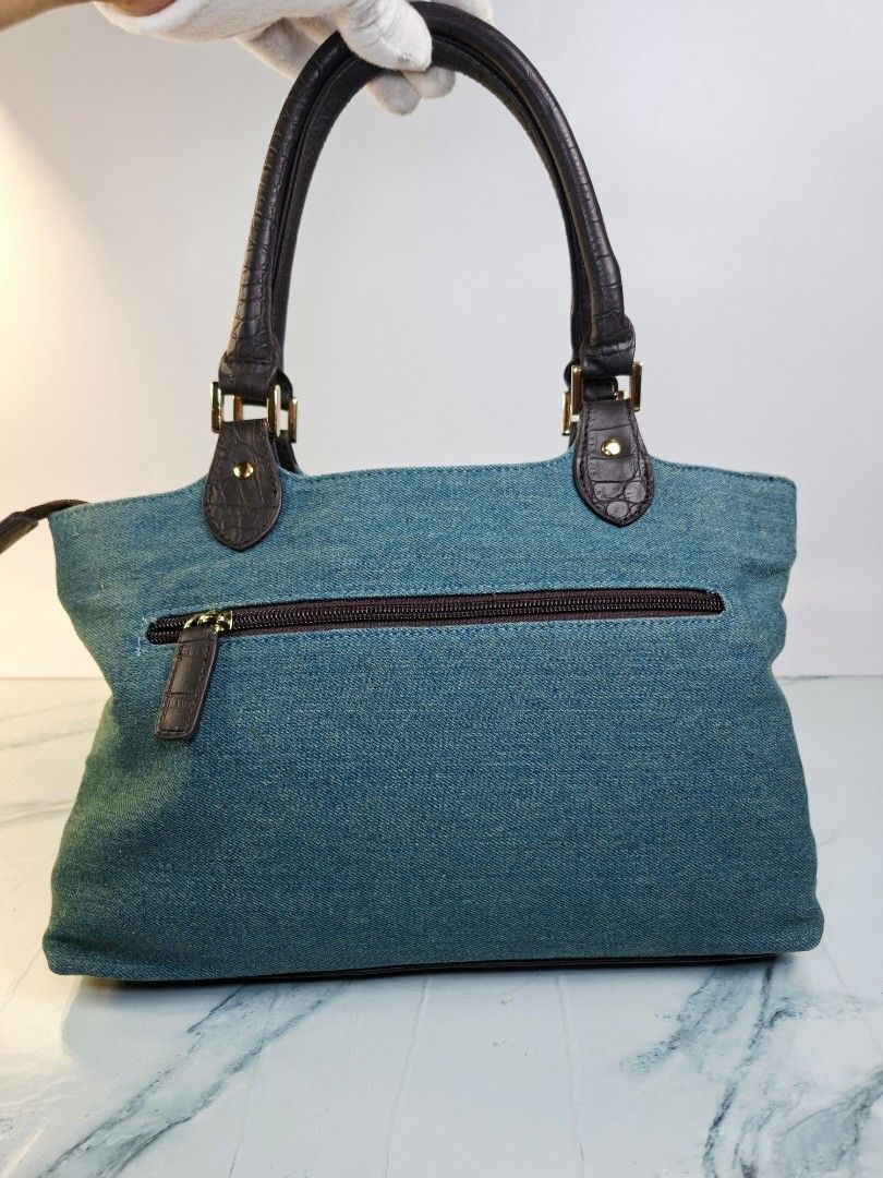 Yuri Kojima Denim and Crocodile Pattern Handbag (Category: Tote Bags) located in Pasay City. Submitted by onick_79 (Listing ID 1470917813, Image 2). Description: -Dimensions L31 x H22 x W14 cm - Brand: Yuri Kojima - Material: Blue denim with dark brown faux crocodile trim - Closure: Secure top zip closure - Pockets: Multiple exterior pockets for easy organization - Hardware: Gold-tone hardware with front brand logo plaque - Design: Double handle,