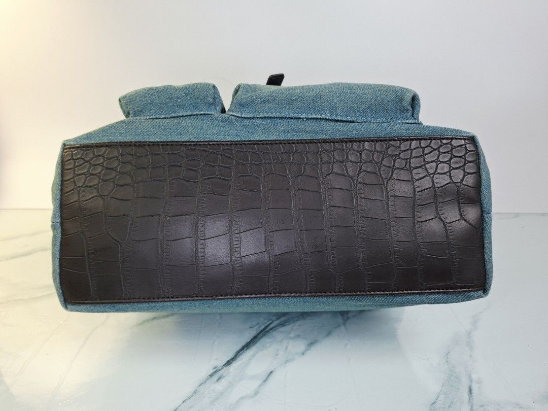 Yuri Kojima Denim and Crocodile Pattern Handbag (Category: Tote Bags) located in Pasay City. Submitted by onick_79 (Listing ID 1470917813, Image 3). Description: -Dimensions L31 x H22 x W14 cm - Brand: Yuri Kojima - Material: Blue denim with dark brown faux crocodile trim - Closure: Secure top zip closure - Pockets: Multiple exterior pockets for easy organization - Hardware: Gold-tone hardware with front brand logo plaque - Design: Double handle,
