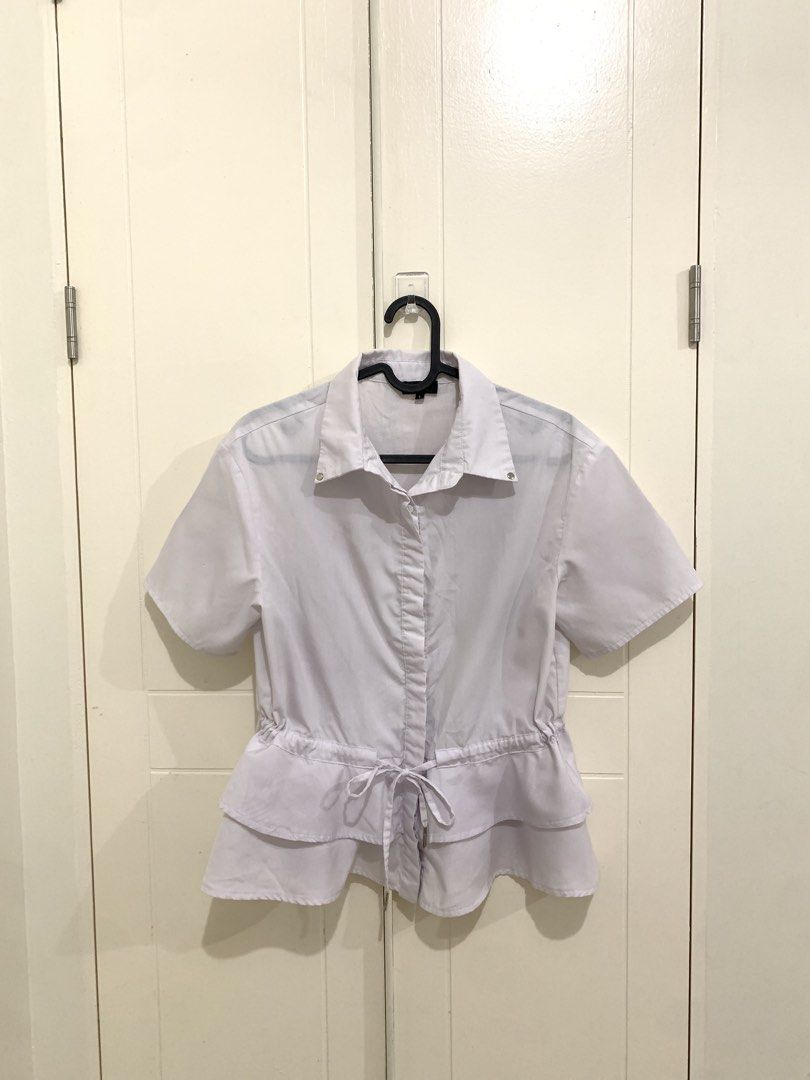 Zalora Collection White Peplum Blouse Size S (Category: Blouses) located in Pasig City. Submitted by lovedbyri (Listing ID 1470861612, Image 1). Description: - Brand: Zalora Collection - Item: White button-down blouse - Size: Small - Features: Short sleeves, lapel collar, and adjustable drawstring waist with double-layered ruffles - Condition: Pre-loved with faint smudge marks and dirt stains on the upper back area - Perfect for smart-casual offi