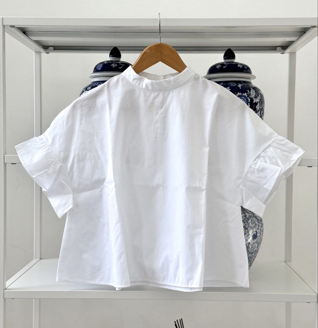 Zara Basic White Ruffle Sleeve Blouse (Category: Blouses) located in Lipa City. Submitted by pauline0303 (Listing ID 1470802623, Image 1). Description: - Brand: Zara Basic - Size: S - Origin: Made in Morocco - Color: Classic White - Fit: Boxy and relaxed - Details: High neckline with back button closure - Sleeves: Short sleeves with cute ruffled flare cuffs - Styling: Versatile basic piece, perfect to match with jeans or skirts - 1 missing middle
