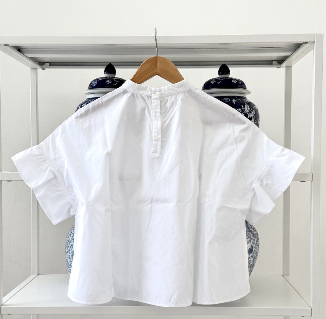 Zara Basic White Ruffle Sleeve Blouse (Category: Blouses) located in Lipa City. Submitted by pauline0303 (Listing ID 1470802623, Image 3). Description: - Brand: Zara Basic - Size: S - Origin: Made in Morocco - Color: Classic White - Fit: Boxy and relaxed - Details: High neckline with back button closure - Sleeves: Short sleeves with cute ruffled flare cuffs - Styling: Versatile basic piece, perfect to match with jeans or skirts - 1 missing middle