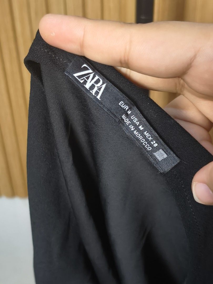 Zara Black Halter Neck Top Size M (Category: Sleeveless) located in Taguig. Submitted by ashie_clothing (Listing ID 1470839360, Image 3). Description: - Brand: Zara - Size: M - Color: Black - Material/Origin: Made in Morocco, lightweight fabric - Design: Halter neck, high neckline, and open back - Styling: Perfect for pairing with jeans or skirts for casual outings - Condition: Excellent / Grab it before it's gone!.