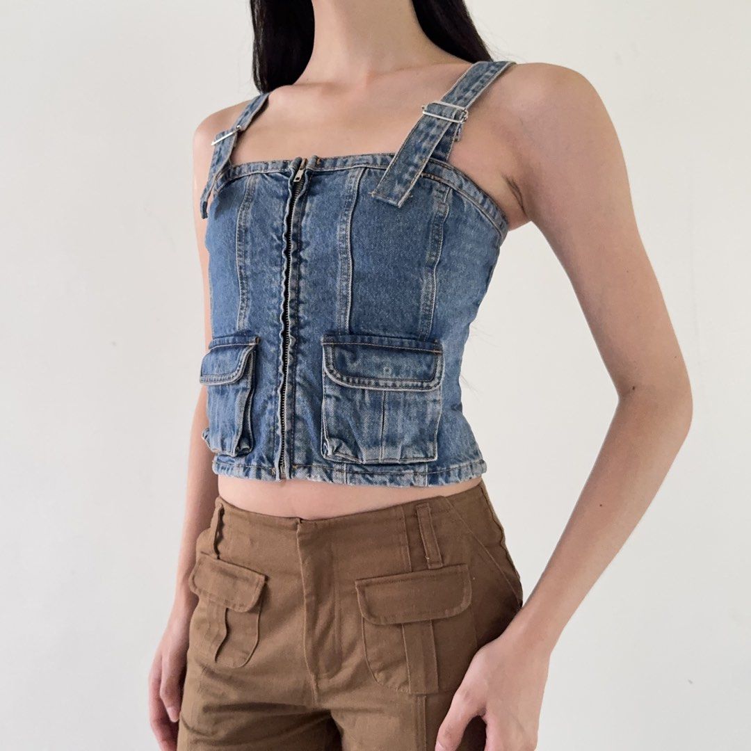 Zara Denim Corset Crop Top (Category: Sleeveless) located in Calamba. Submitted by quietarchive (Listing ID 1470820653, Image 3). Description: - Brand: Zara - Size: XS - Style: Denim corset crop top in classic blue wash - Closure: Convenient front zipper - Details: Two front cargo pockets and adjustable buckle straps - Fit: Smocked back panel for extra stretch and comfort.