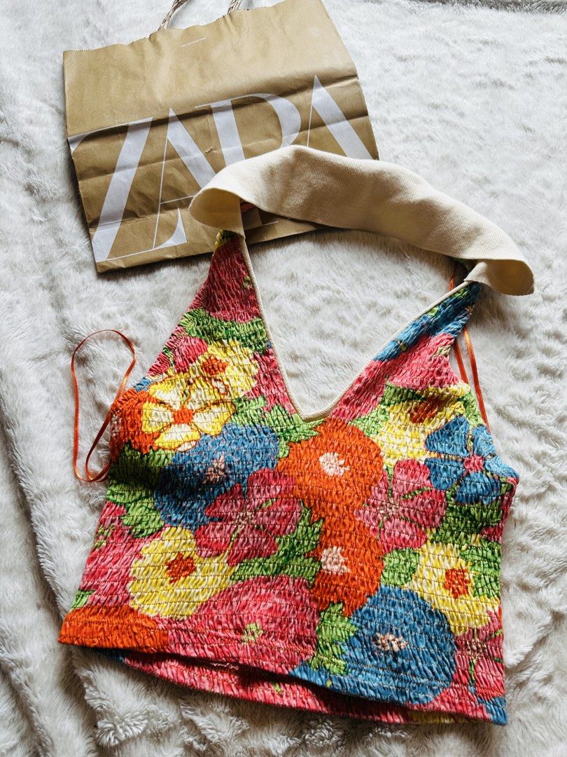 Zara Floral Smocked Halter Top (Category: Sleeveless) located in Marikina City. Submitted by zarahlovestoshop (Listing ID 1470806618, Image 2). Description: - Brand: Zara - Style: Halter neck crop top with V-neckline and open back - Design: Vibrant floral pattern with a contrast cream-coloured collar - Material: Super soft and comfortable smocked elastic stretch fabric - Condition: Great piece for warm weather and summer days -Medium -SF c/o buye
