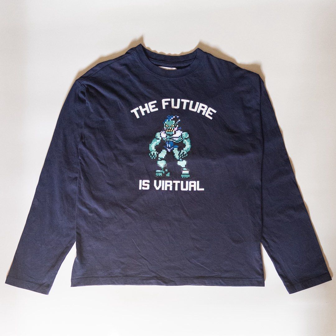 Zara Graphic Long Sleeve Shirt (Category: Tshirts & Polo Shirts ) located in Makati City. Submitted by changsversion (Listing ID 1470797417, Image 1). Description: - Brand: Zara - Size: 13-14 years (164 cm) - Color: Dark navy blue - Material: Comfortable 100% cotton - Design: 'THE FUTURE IS VIRTUAL' pixel monster print on front, grid monster design with 'VIRTUAL UNIVERSE' text on back - Condition: Great for daily casual wear.