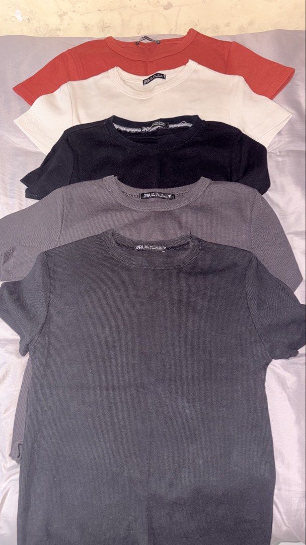 Zara ribbed basic short sleeve t-shirts bundle pack of 5 (Category: Shirts) located in Quezon City. Submitted by shrlane (Listing ID 1470889409, Image 1). Description: - Brand: Zara -Best fit till semi M - Quantity: Bundle of 5 short-sleeve t-shirts - Colors: Dark charcoal grey, medium grey, black, cream white, and red - Style: Crew neck, ribbed textured fabric, stretchy - Perfect daily wardrobe staples!.