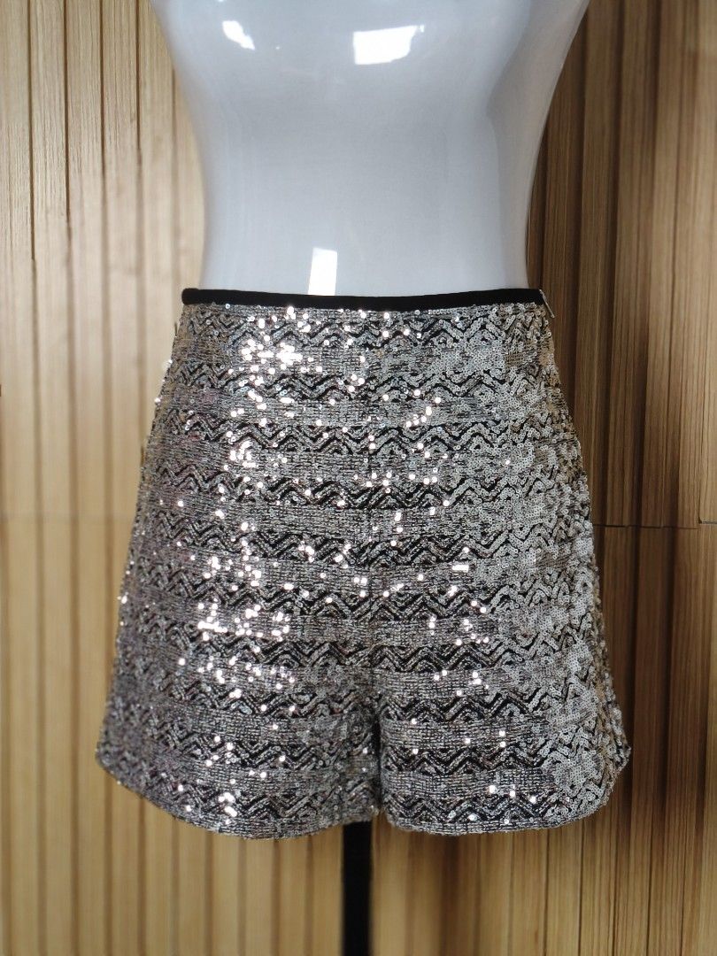 Zara Silver Sequins Shorts Size M (Category: Shorts) located in Taguig. Submitted by ashie_clothing (Listing ID 1470839420, Image 2). Description: - Brand: Zara - Size: Medium (US M, MEX 28) - Condition: Brand new with tag attached - Material/Origin: Made in Morocco - Design: Sparkly zig-zag pattern all over - Details: Black waistband and side zipper closure.