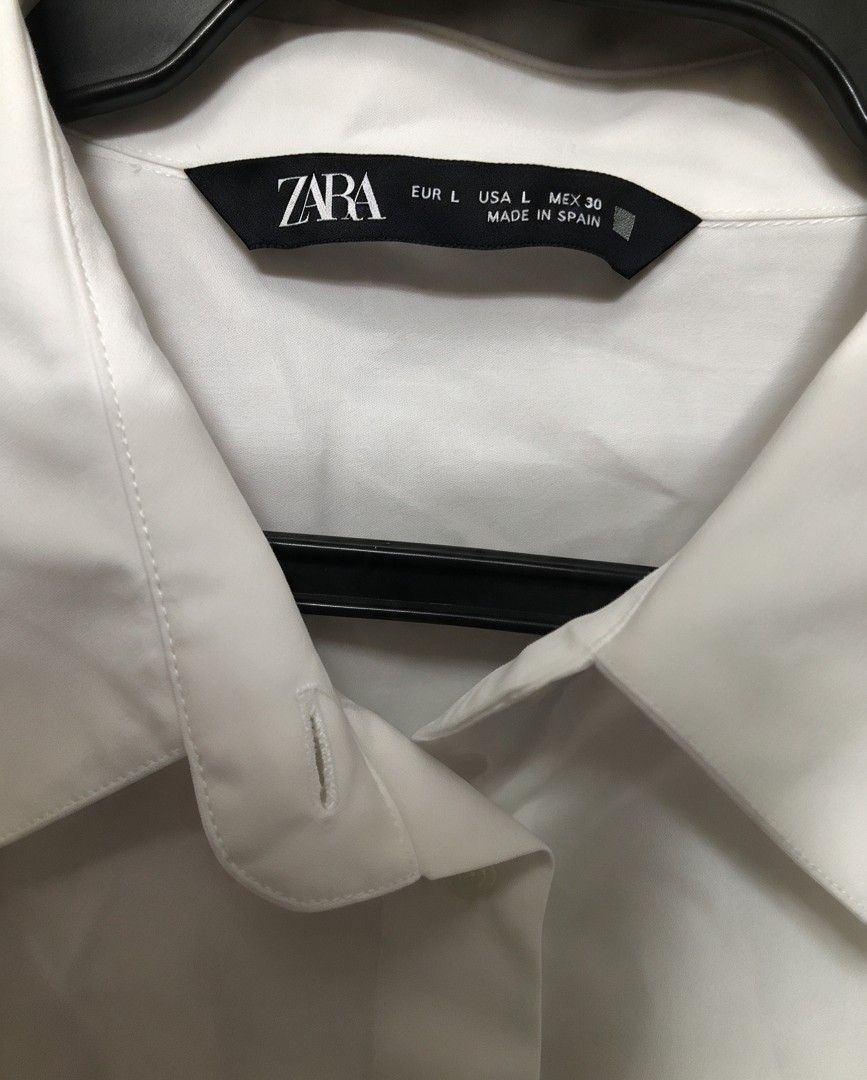 Zara White Button-Down Shirt Size L (Category: Blouses) located in Manila. Submitted by charlottej01596 (Listing ID 1470743790, Image 2). Description: - Brand: Zara - Color: White - Size: L (EUR, USA, MEX) - Origin: Made in Spain - Style: Minimalist button-down with collared neckline and long sleeves with wide cuffs - Condition/Vibe: Clean, classic staple piece, easy to style for work or casual wear.