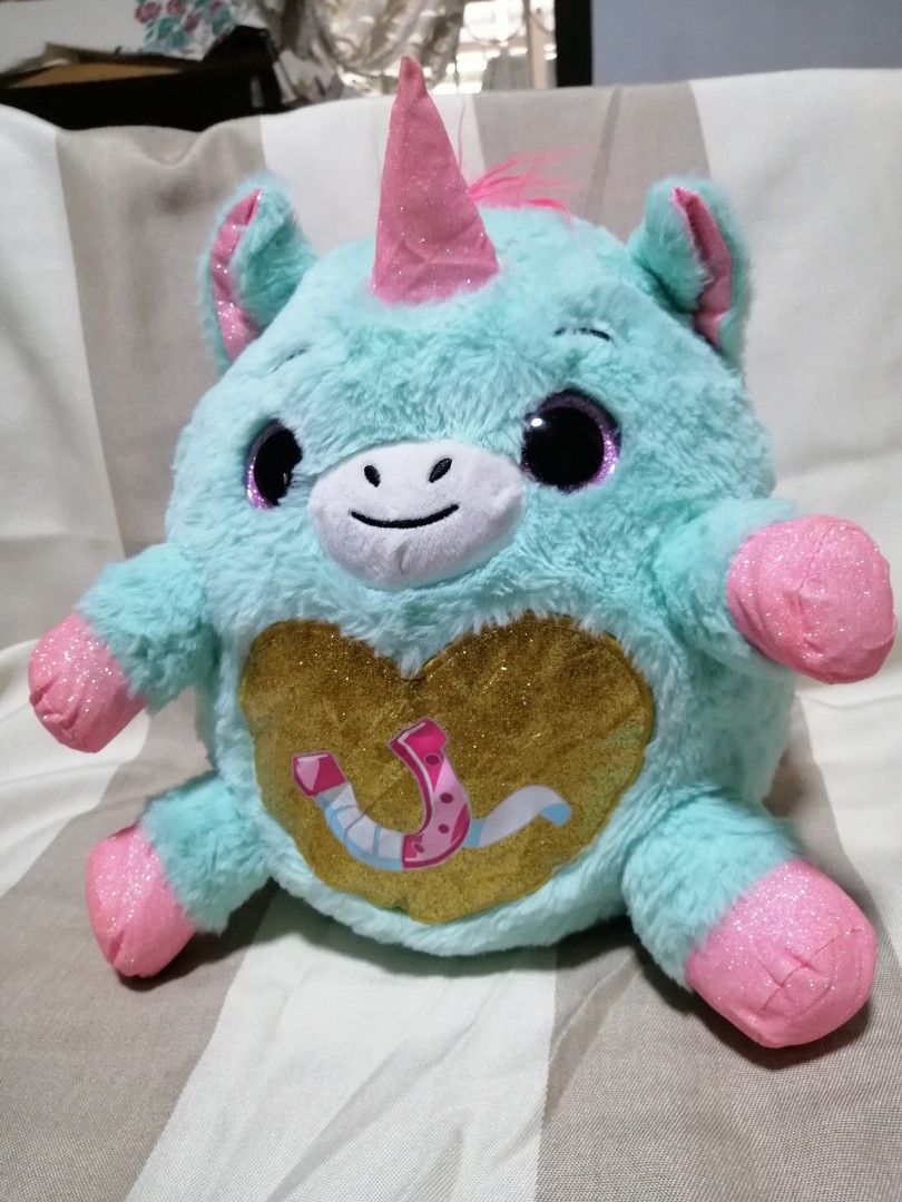 Zuru Rainbocorns Plush (Category: Plushies & Soft Toys) located in Angono. Submitted by rlinee_93 (Listing ID 1470794256, Image 3). Description: - Features: Big sparkly black eyes, pink sparkly horn, and pink glitter paws - Detail: Gold glitter heart on the tummy with a horseshoe graphic.