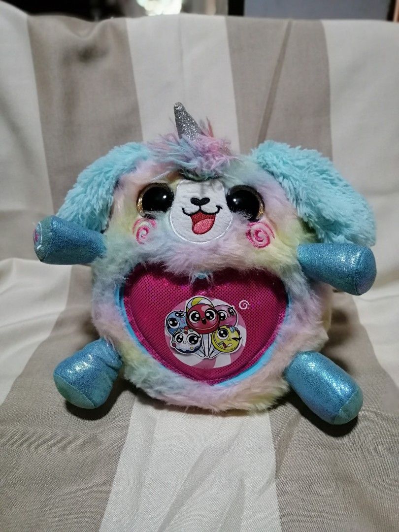 Zuru Rainbocorns Plush (Category: Plushies & Soft Toys) located in Angono. Submitted by rlinee_93 (Listing ID 1470794256, Image 2). Description: - Features: Big sparkly black eyes, pink sparkly horn, and pink glitter paws - Detail: Gold glitter heart on the tummy with a horseshoe graphic.