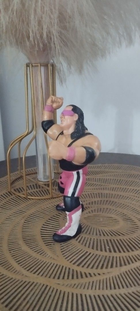 1990 Hasbro WWF Bret "The Hitman" Hart (Category: Action & Battle Toys) located in Manila. Submitted by ventajetoyz625 (Listing ID 1470954471, Image 3). Description: - Vintage WWF Hasbro Bret Hart action figure - Features his iconic pink and black singlet with heart details and pink sunglasses - Right arm sculpted in his signature pose - Condition: Shows minor paint wear on boots and hair due to age and play - Ideal for retro wrestling fans and v