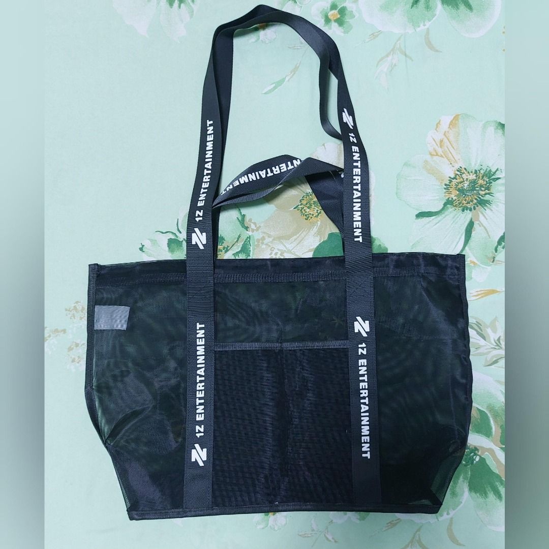 1Z Entertainment Black Mesh Tote Bag (Category: Other Merchandise) located in Pasig City. Submitted by keithra (Listing ID 1470935155, Image 2). Description: - Official 1Z Entertainment merchandise - Color: Black mesh with striking white strap branding - Features: Double shoulder straps and a convenient front pocket - Material: Lightweight and see-through - Versatile: Perfect for everyday use, errands, or concerts - Condition: Use only once durin