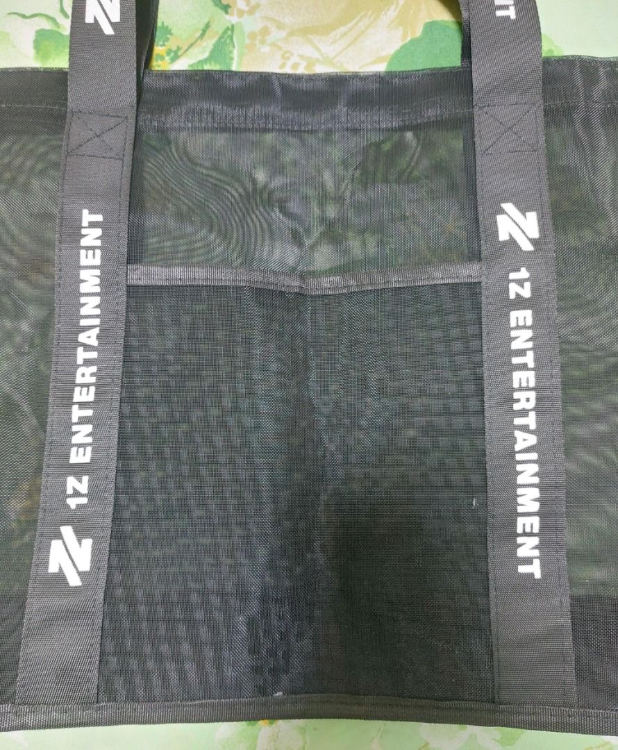 1Z Entertainment Black Mesh Tote Bag (Category: Other Merchandise) located in Pasig City. Submitted by keithra (Listing ID 1470935155, Image 3). Description: - Official 1Z Entertainment merchandise - Color: Black mesh with striking white strap branding - Features: Double shoulder straps and a convenient front pocket - Material: Lightweight and see-through - Versatile: Perfect for everyday use, errands, or concerts - Condition: Use only once durin