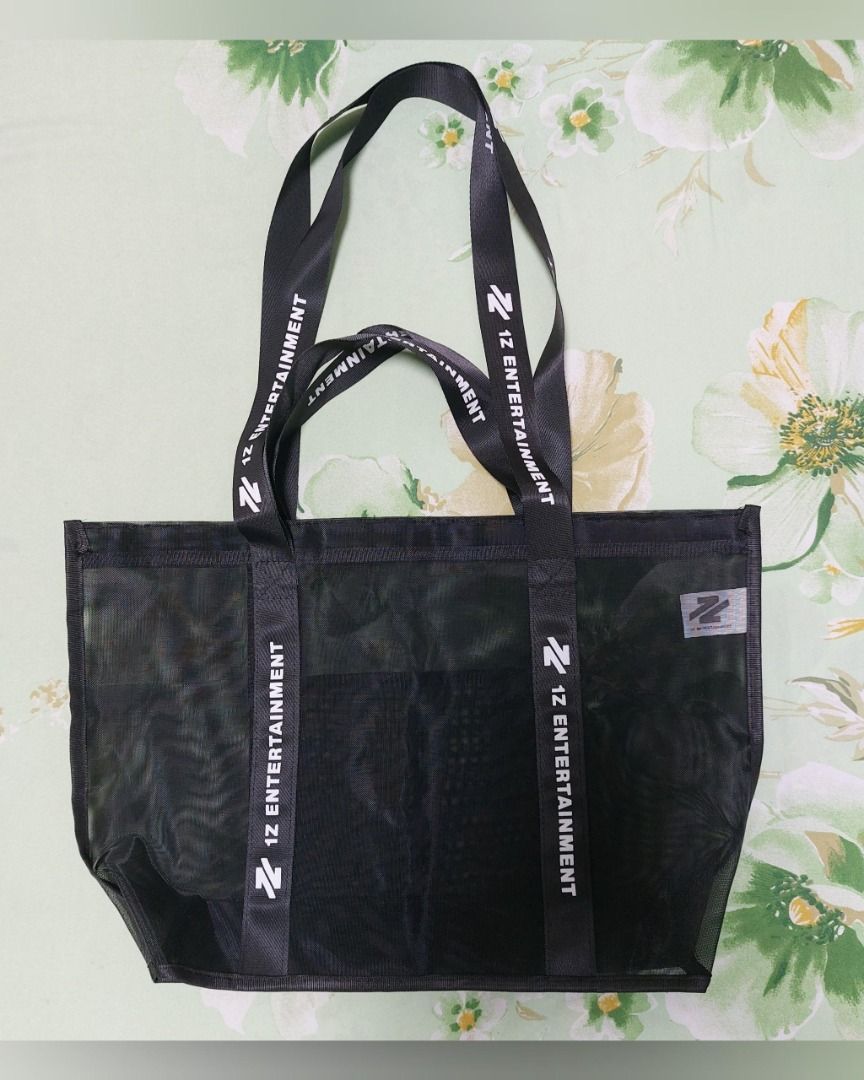 1Z Entertainment Black Mesh Tote Bag (Category: Other Merchandise) located in Pasig City. Submitted by keithra (Listing ID 1470935155, Image 1). Description: - Official 1Z Entertainment merchandise - Color: Black mesh with striking white strap branding - Features: Double shoulder straps and a convenient front pocket - Material: Lightweight and see-through - Versatile: Perfect for everyday use, errands, or concerts - Condition: Use only once durin