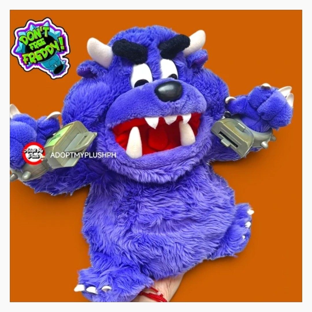 2001 Spin Master Don't Free Freddy plush (Category: Interactive Toys) located in Taguig. Submitted by adopt.my.plush.ph (Listing ID 1470963884, Image 1). Description: Don't Free Freddy purple talking monster plush toy, approx. 13 inches, released by Spin Master in 2001. *as is, untested & presumed not working *as is, rust &/or alkaline battery corrosion noted on its battery spring Key Features *Design: A fuzzy purple monster featuring white horns