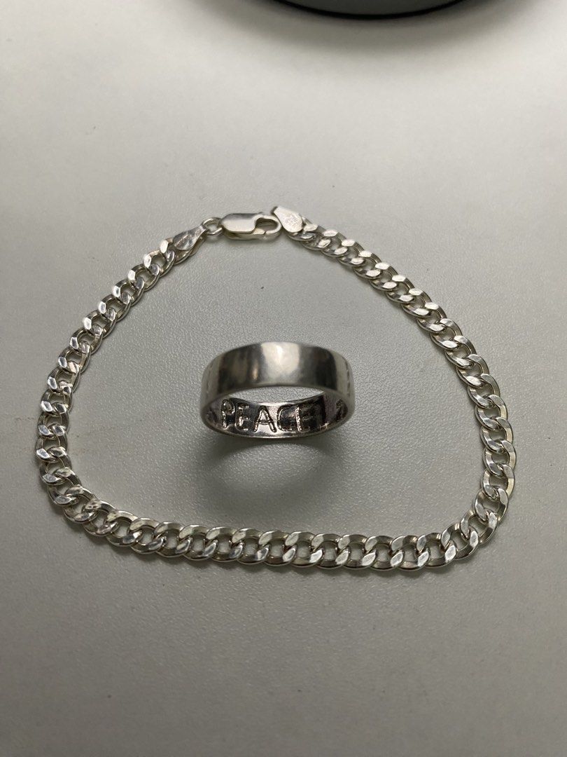 92.5 Sterling Silver Curb Chain Bracelet and Ring (Category: Jewelry) located in Baguio. Submitted by masterroller (Listing ID 1471065715, Image 2). Description: Matching 92.5 silver jewelry set including a classic curb chain bracelet with lobster clasp and a wide band ring stamped with 'PEACE' on the inside. Great everyday accessories to wear together or separately..