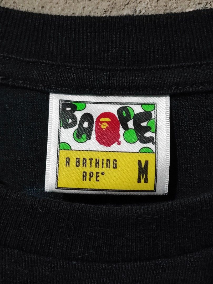 A BATHING APE - BAPE 1ST CAMOUFLAGE ASNKA TEE (Category: Tshirts & Polo Shirts ) located in Iloilo. Submitted by gooddimes (Listing ID 1471074141, Image 3). Description: A Bathing Ape - Bape 1st Camouflage 'ASNKA' Tee Authentic Size on tag: Medium Dimes: 19x26L Issue/s: None Color rate: 9.5/10 Excellent condition ₱2,499 +sf Reminders: - All items are thrifted, please manage your expectations - Color may vary due to lighting - Please wash before u