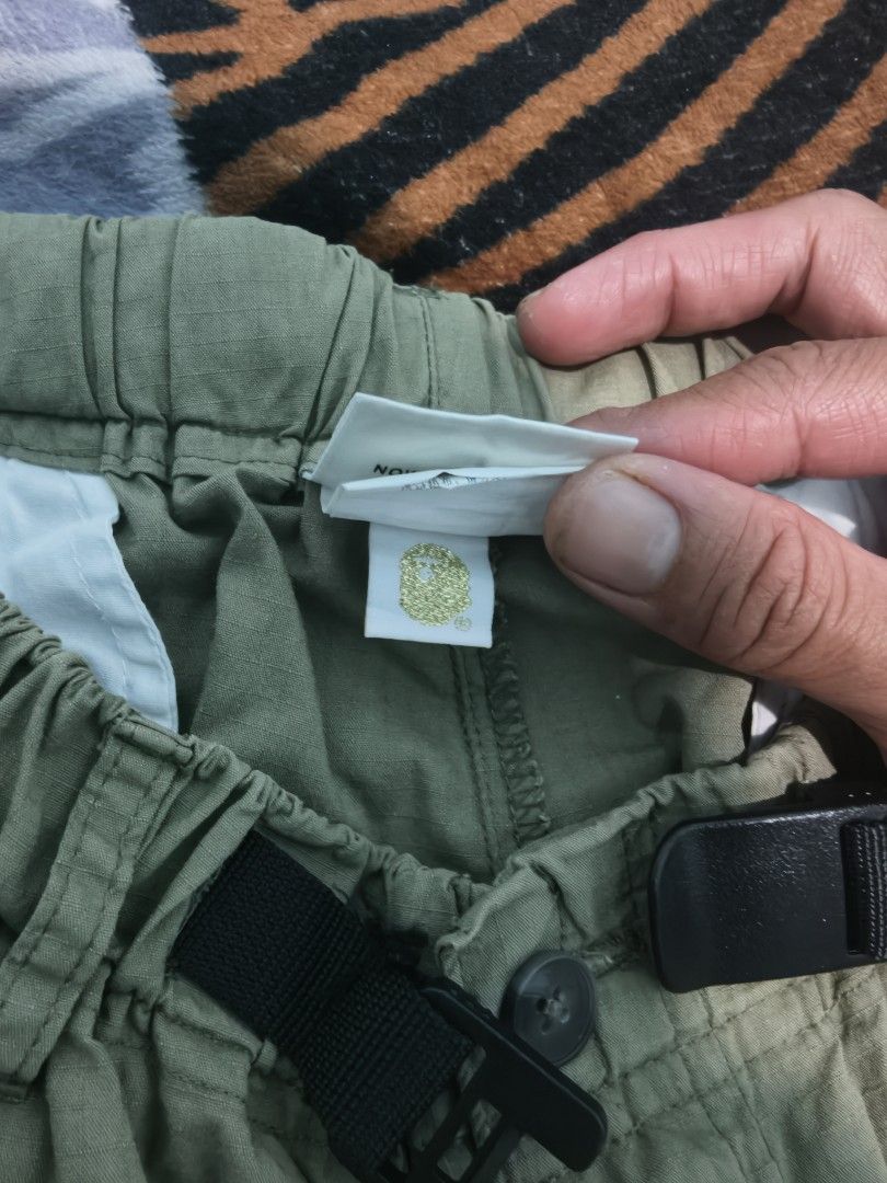 A Bathing Ape BAPE Green Cargo Shorts Size L (Category: Shorts) located in Caloocan City. Submitted by cccccc333888 (Listing ID 1471052097, Image 2). Description: - Brand: A Bathing Ape (BAPE) - Item: Green cargo shorts - Size: Large - Details: Built-in adjustable black web belt with plastic buckle and elastic waistband - Branding: Small embroidered ape logo near the bottom hem - Condition/Build: Clean fabric construction with reinforced stitchin