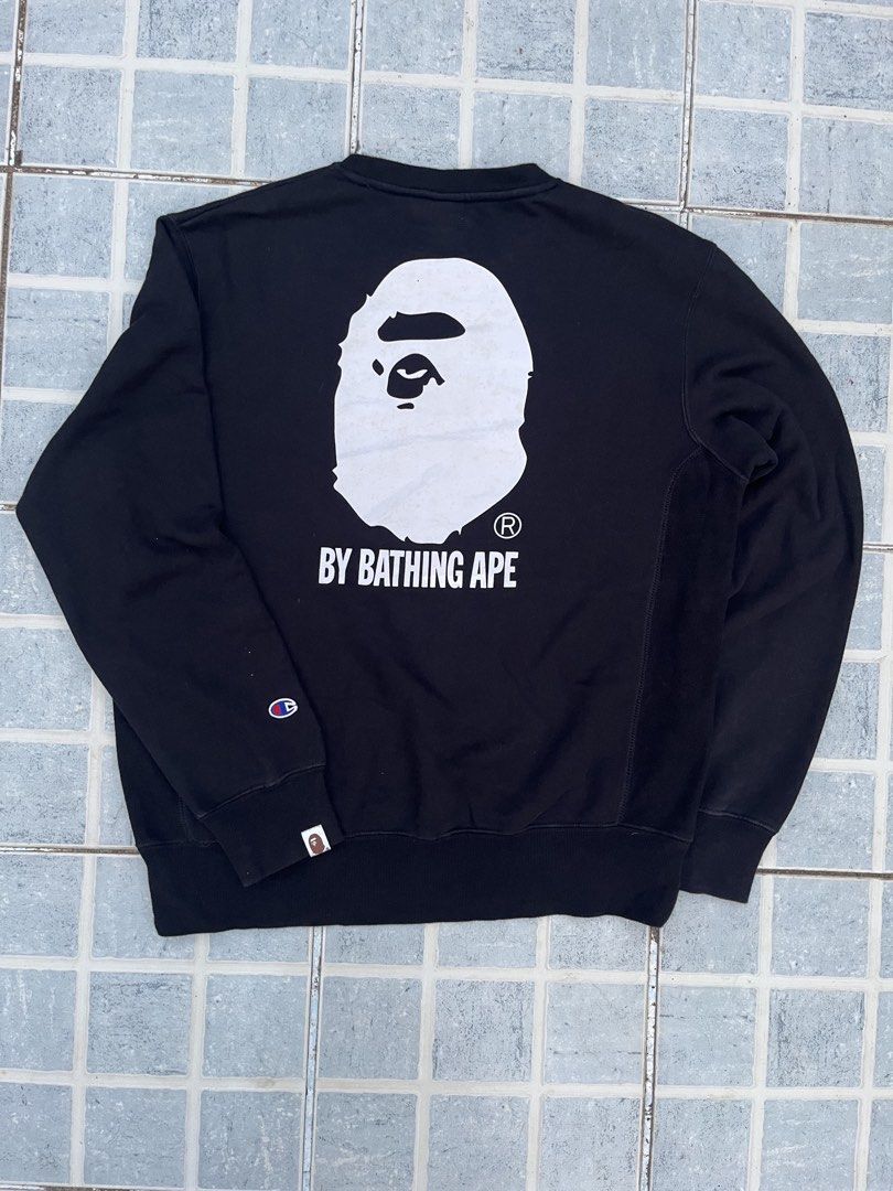 A Bathing Ape x Champion Black Reverse Weave Sweatshirt (Category: Coats, Jackets and Outerwear) located in Leyte. Submitted by odd_noodle (Listing ID 1470988224, Image 2). Description: - Brand: BAPE x Champion - Item: Reverse Weave Sweatshirt - Color: Black - Size: XL - Details: Classic Champion script logo embroidery on chest - Back Graphic: Giant A Bathing Ape head print - Accents: Collaborative woven labels at neckline and sleeve cuff - Mater