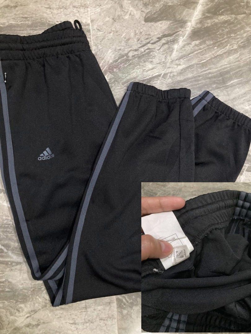 Adidas 3-stripe black training or track pants (Category: Activewear) located in General Santos City (Dadiangas). Submitted by amorhesthrift (Listing ID 1464639056, Image 3). Description: Good to new condition W-30-34 L35.6 The selected region showcases a pair of black Adidas training pants equipped with practical zipper pockets.