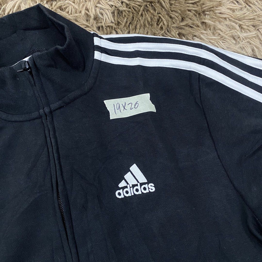 Adidas Black Track Jacket Size XS (Category: Coats, Jackets and Outerwear) located in Cagayan de Oro. Submitted by sepamorash53558 (Listing ID 1470965853, Image 2). Description: - Brand: Adidas - Color: Black with white three-stripe details - Logo: Embroidered on the chest - Features: Stand-up collar, full zip closure, side pockets - Size: A/XS (Approx. 19 inches chest, 26 inches length) - Material: Cotton and polyester blend - Origin: Made in Ch