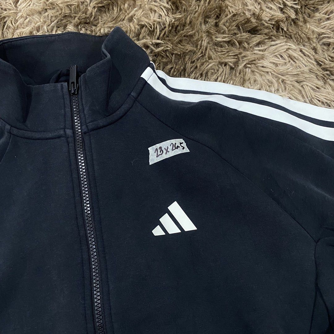 Adidas Black Track Jacket with White Stripes Size S (Category: Coats, Jackets and Outerwear) located in Cagayan de Oro. Submitted by sepamorash53558 (Listing ID 1470965824, Image 2). Description: - Brand: Adidas - Color: Black with classic white sleeve stripes - Size: Small (S) - Material: Comfortable cotton and recycled polyester blend - Technology: Integrated Climawarm for extra warmth - Design: Small front logo, large back Adidas lettering, fu