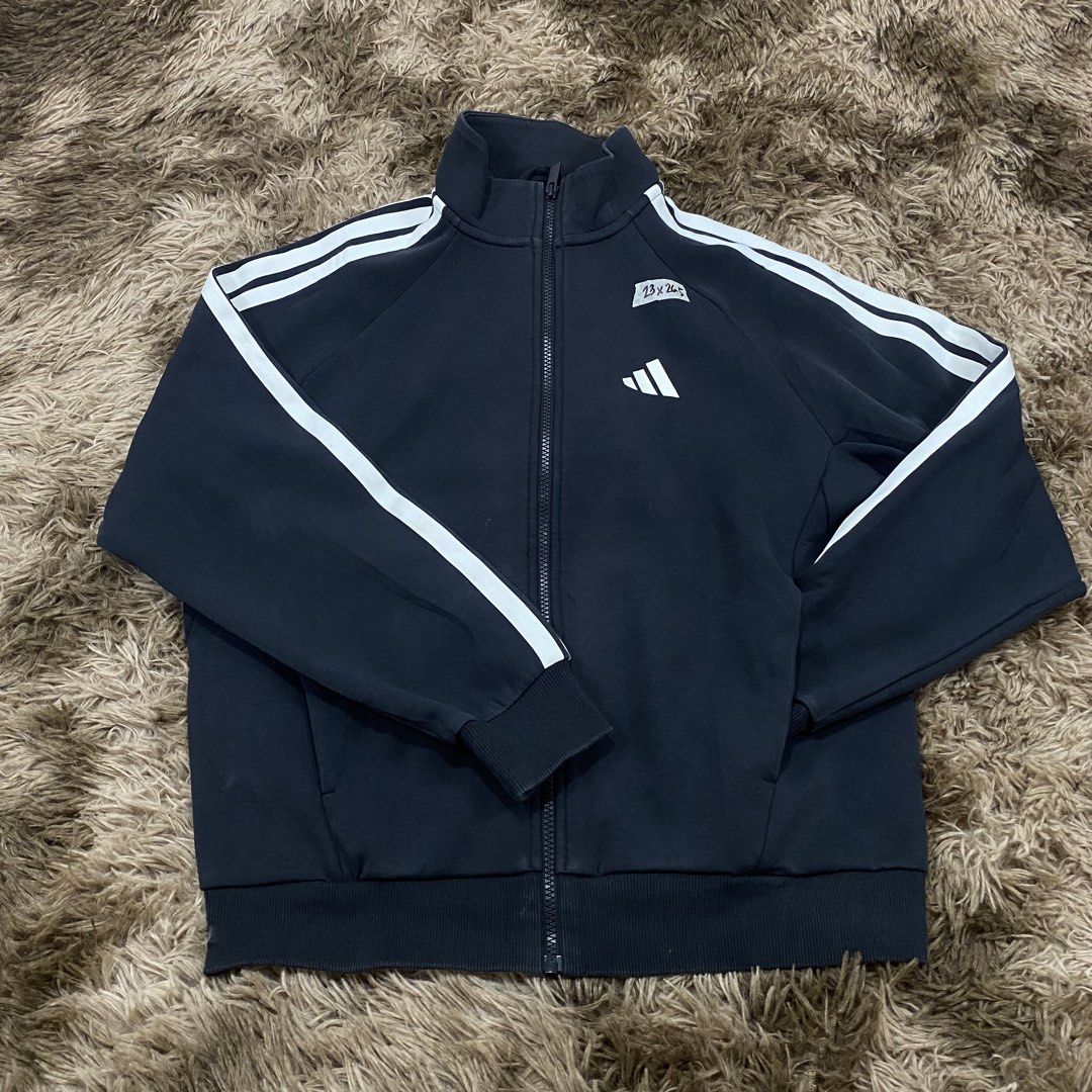 Adidas Black Track Jacket with White Stripes Size S (Category: Coats, Jackets and Outerwear) located in Cagayan de Oro. Submitted by sepamorash53558 (Listing ID 1470965824, Image 1). Description: - Brand: Adidas - Color: Black with classic white sleeve stripes - Size: Small (S) - Material: Comfortable cotton and recycled polyester blend - Technology: Integrated Climawarm for extra warmth - Design: Small front logo, large back Adidas lettering, fu