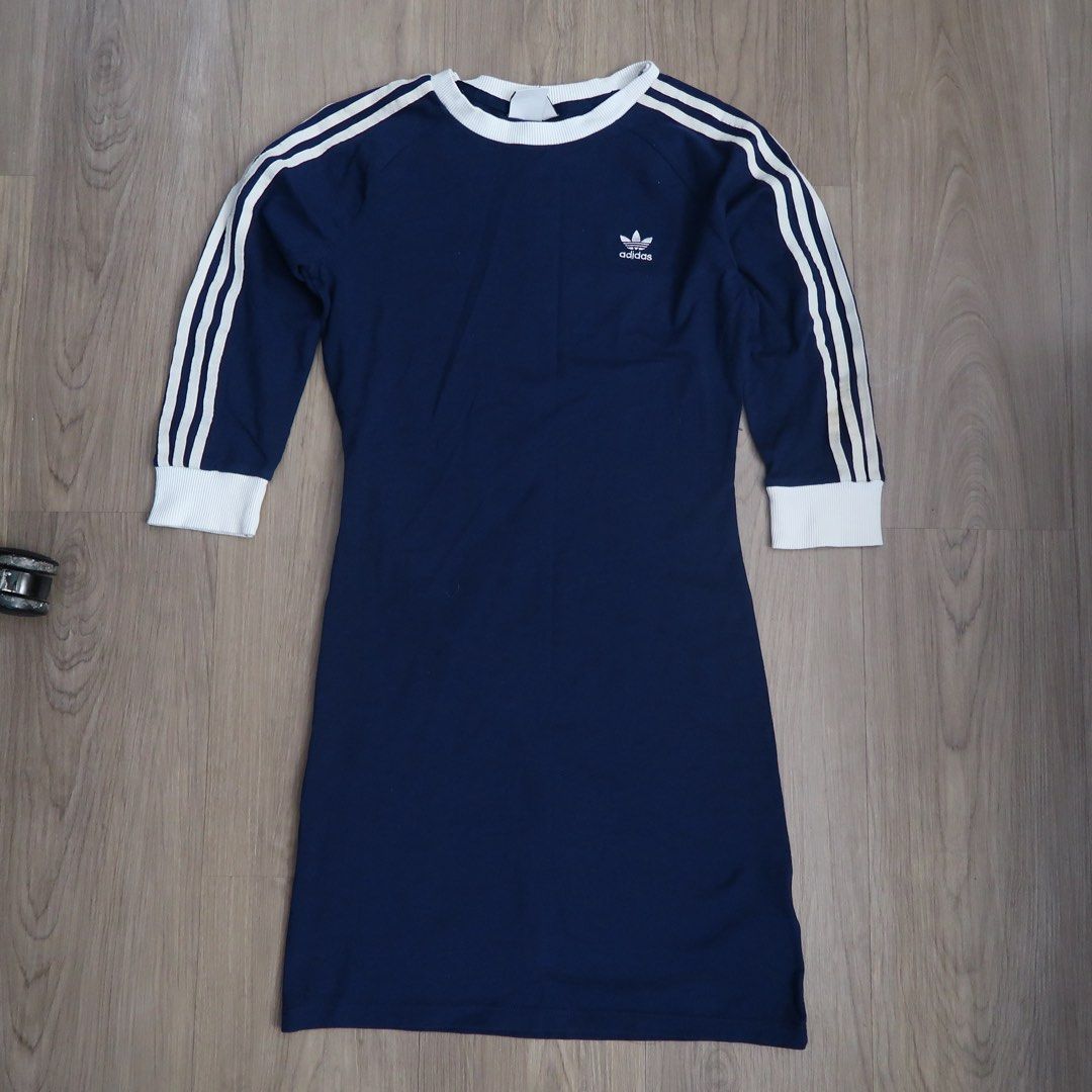 Adidas Blue White Three Stripe Dress (Category: Dresses) located in Manila. Submitted by mixi_lexi (Listing ID 1471039920, Image 1). Description: - Brand: Adidas - Color: Dark blue with white contrast details - Design: Classic 3-stripes on sleeves, ribbed crew neck and cuffs, iconic Trefoil logo on chest - Size: UK 12 / US M / D 38 / F 40 - Material: Soft and comfortable cotton blend - Condition: Excellent / Great sporty casual look - Mode of Pay
