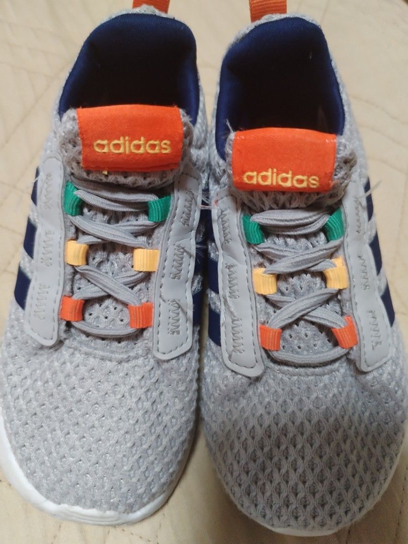 Adidas Kids Grey Sneakers (Category: Babies & Kids Fashion) located in Manila. Submitted by mrpquiamba34669 (Listing ID 1471016073, Image 1). Description: - Brand/Model: Adidas Kids Sneakers - Color: Grey mesh with navy three stripes - Details: Colourful accents on laces, heel, and pull tab - Sole: White midsole with green rubber outsole sections - Fit/Style: Slip-on design with elastic lacing system - Condition: Soles show light dirt from walkin