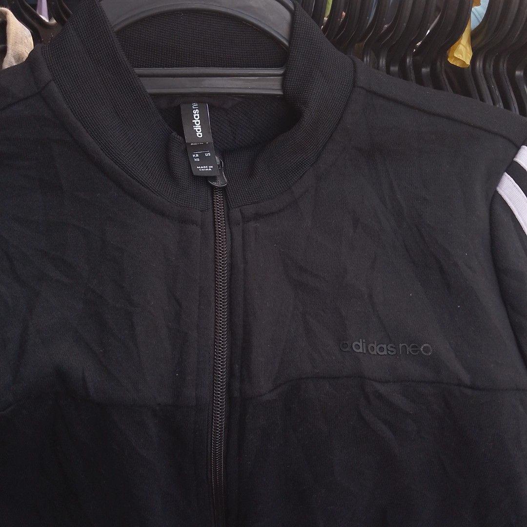 Adidas Neo Black Track Jacket With White Stripes (Category: Coats, Jackets and Outerwear) located in Manila. Submitted by jonahq.9 (Listing ID 1471119057, Image 2). Description: - Brand: Adidas Neo - Color: Black with classic white three stripes - Size: A/S (US/KR sizing) - Material: 75% polyester, 25% rayon - Features: Full zip front, ribbed collar, cuffs, hem, and subtle debossed logo on chest - Condition: Great casual sporty layering piece.