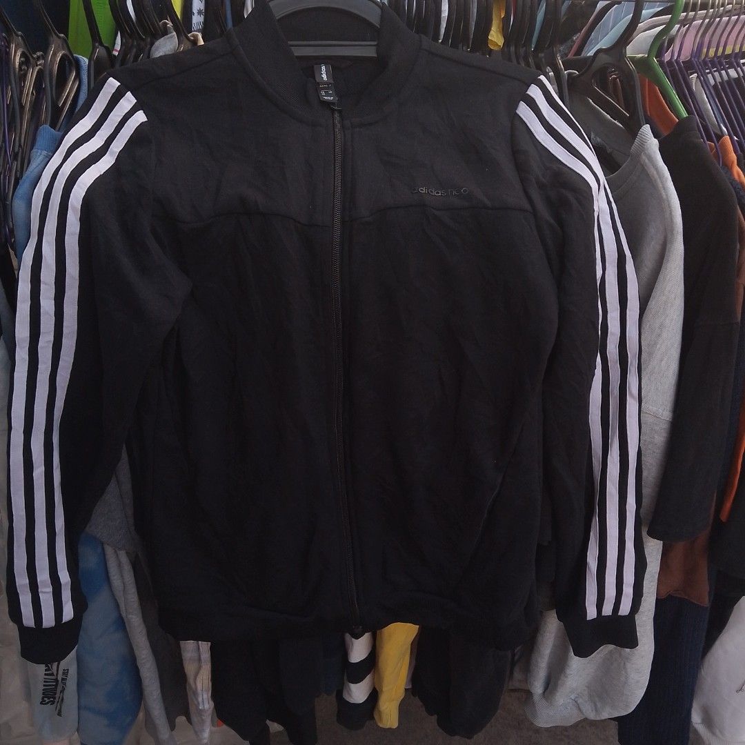Adidas Neo Black Track Jacket With White Stripes (Category: Coats, Jackets and Outerwear) located in Manila. Submitted by jonahq.9 (Listing ID 1471119057, Image 1). Description: - Brand: Adidas Neo - Color: Black with classic white three stripes - Size: A/S (US/KR sizing) - Material: 75% polyester, 25% rayon - Features: Full zip front, ribbed collar, cuffs, hem, and subtle debossed logo on chest - Condition: Great casual sporty layering piece.