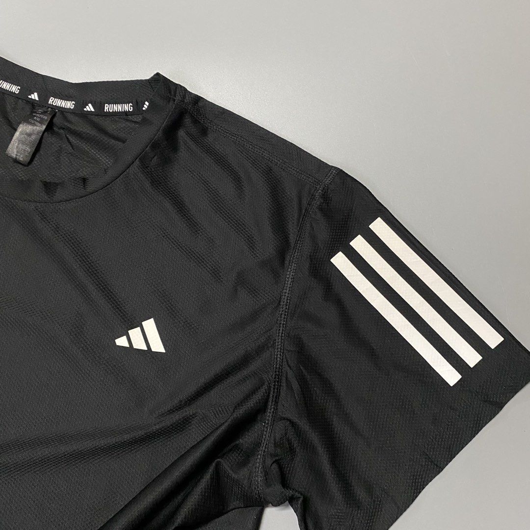 Adidas OTR Running Tee Black Size XL (Category: Activewear) located in Pagadian. Submitted by 420thriftclothes (Listing ID 1471100077, Image 3). Description: - Brand: Adidas - Color: Black - Size: XL - Material: Recycled polyester and elastane blend - Fabric: Lightweight mesh for breathability and cooling - Design: Reflective three-stripe branding on sleeves - Detail: Interior collar features printed running text tape - Origin: Made in Indonesia 