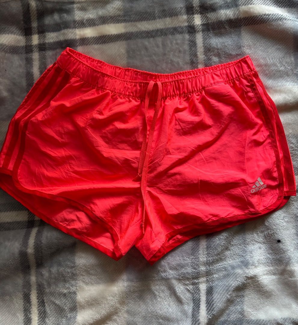 Adidas Red Athletic Running Shorts (Category: Shorts) located in Danao, Cebu. Submitted by kentoy25 (Listing ID 1471007664, Image 2). Description: - Brand: Adidas - Color: Bright red with white logo on the hem - Fit: Elastic waistband with adjustable drawstring - Comfort: Lightweight fabric with built-in inner lining - Condition: Clean interior tag, ready to wear - Ideal for: Workouts, running, and daily activewear.