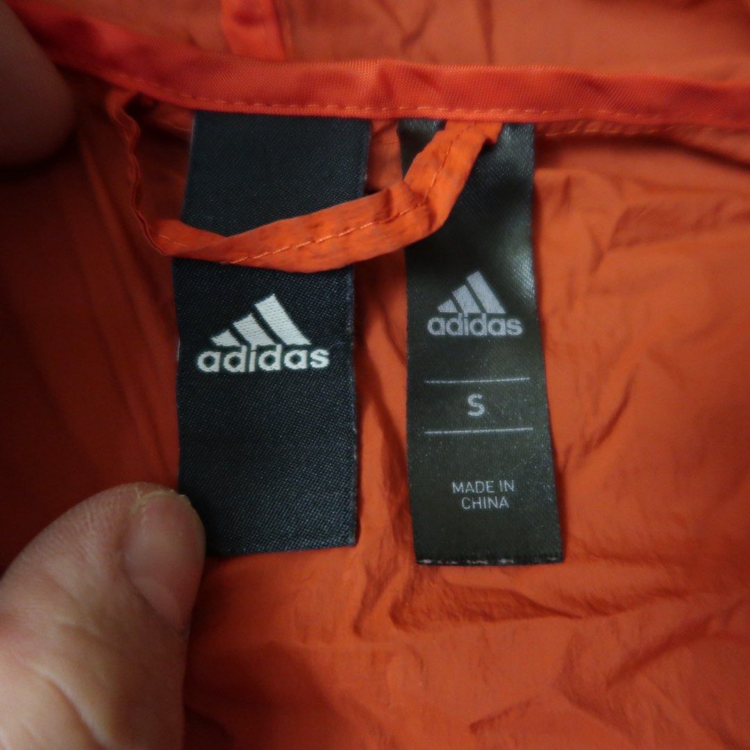 Adidas Red Hooded Windbreaker Jacket Size S (Category: Coats, Jackets and Outerwear) located in Manila. Submitted by mixi_lexi (Listing ID 1471038528, Image 2). Description: - Brand: Adidas - Color: Bright red - Size: S - Material: Lightweight windbreaker fabric - Features: Full zip front, front hand pockets, drawstring hood - Details: Iconic Adidas logo printed near the bottom hem and on the sleeve - Origin: Made in China - Condition: Excellent.