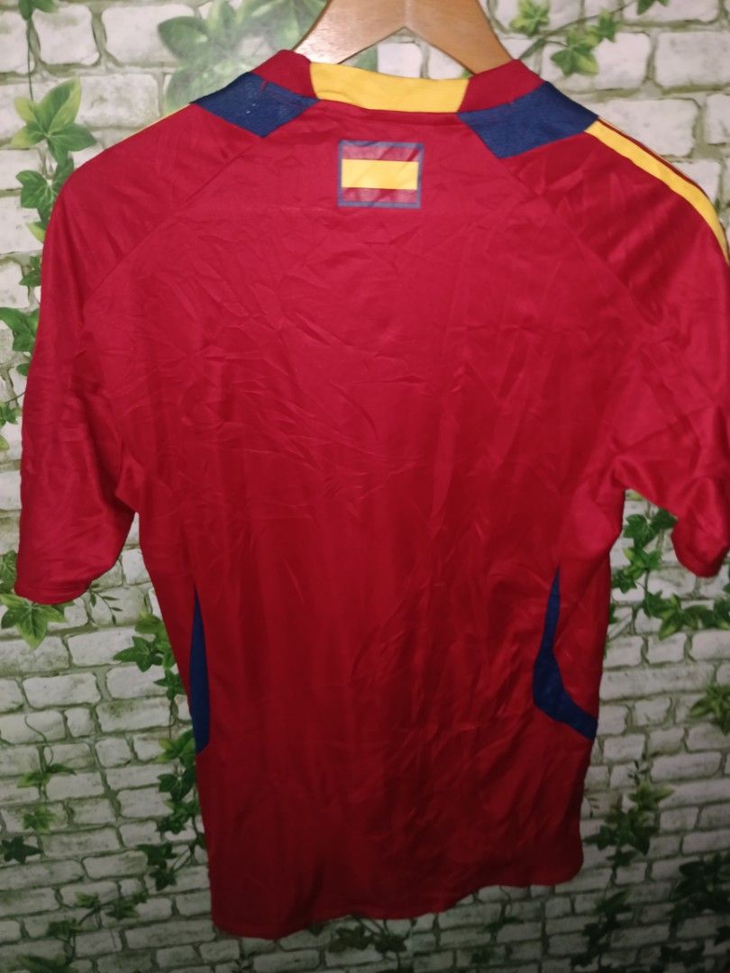 Adidas Spain 2012-13 Formotion Training Shirt Size M (Category: Activewear) located in Carcar. Submitted by rolandobac92675 (Listing ID 1470969710, Image 3). Description: - Authentic Spain national team training shirt (2012-2013 season) - Color: Red with blue and yellow accents - Features Adidas Formotion technology - Printed crest with 1 championship star on the chest - Size: Medium - Made in China (Product Code: X16736) - Perfect condition for 