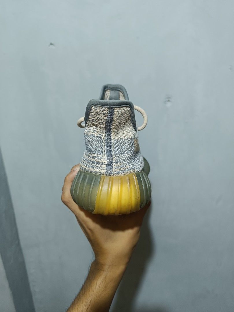 Adidas Yeezy Boost 350 V2 Ash Blue (Category: Sneakers) located in Manila. Submitted by nothingtosay_00 (Listing ID 1470944192, Image 2). Description: - Model: Adidas Yeezy Boost 350 V2 - Colorway: Ash Blue - Upper: Primeknit with distinct side stripe - Sole: Translucent yellow-tinted midsole with exposed Boost cushioning - Condition: Interior lining is clean with three-stripe heel detail; soles show minor dirt from handling - Inclusions: Comes w