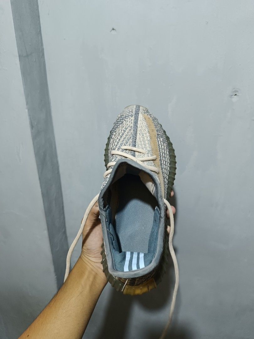 Adidas Yeezy Boost 350 V2 Ash Blue (Category: Sneakers) located in Manila. Submitted by nothingtosay_00 (Listing ID 1470944192, Image 3). Description: - Model: Adidas Yeezy Boost 350 V2 - Colorway: Ash Blue - Upper: Primeknit with distinct side stripe - Sole: Translucent yellow-tinted midsole with exposed Boost cushioning - Condition: Interior lining is clean with three-stripe heel detail; soles show minor dirt from handling - Inclusions: Comes w