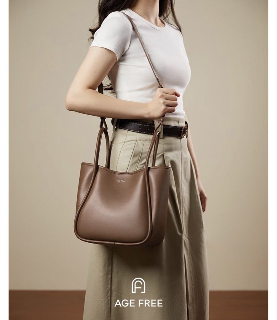 AGE FREE Brown Shoulder Tote Bag with Pouch (Category: Shoulder Bags) located in Manila. Submitted by katgarciamnl (Listing ID 1470933023, Image 1). Description: - Color: Brown - Material: Soft leather-like, lightweight at just 0.59kg - Dimensions: 29cm (L) x 24cm (H) x 14cm (W) - Capacity: Easily fits A4 magazines and 11-inch tablets with plenty of room for daily essentials - Strap: Adjustable and removable (approx. 84 to 93cm) - Bonus: Comes wi